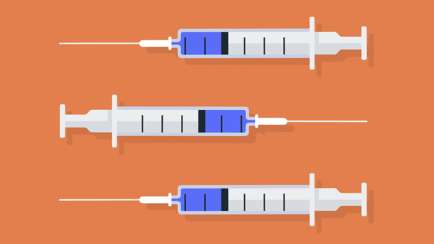 橙色背景下三支注射疫苗的注射器