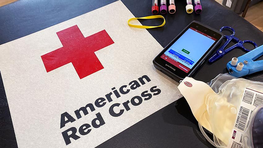 sign of american red cross with blood vials and phone